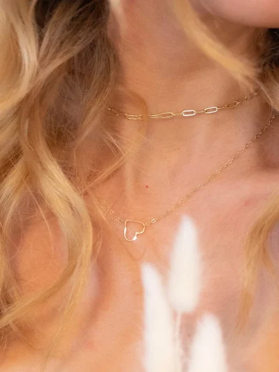 blond woman wearing gold heart necklace