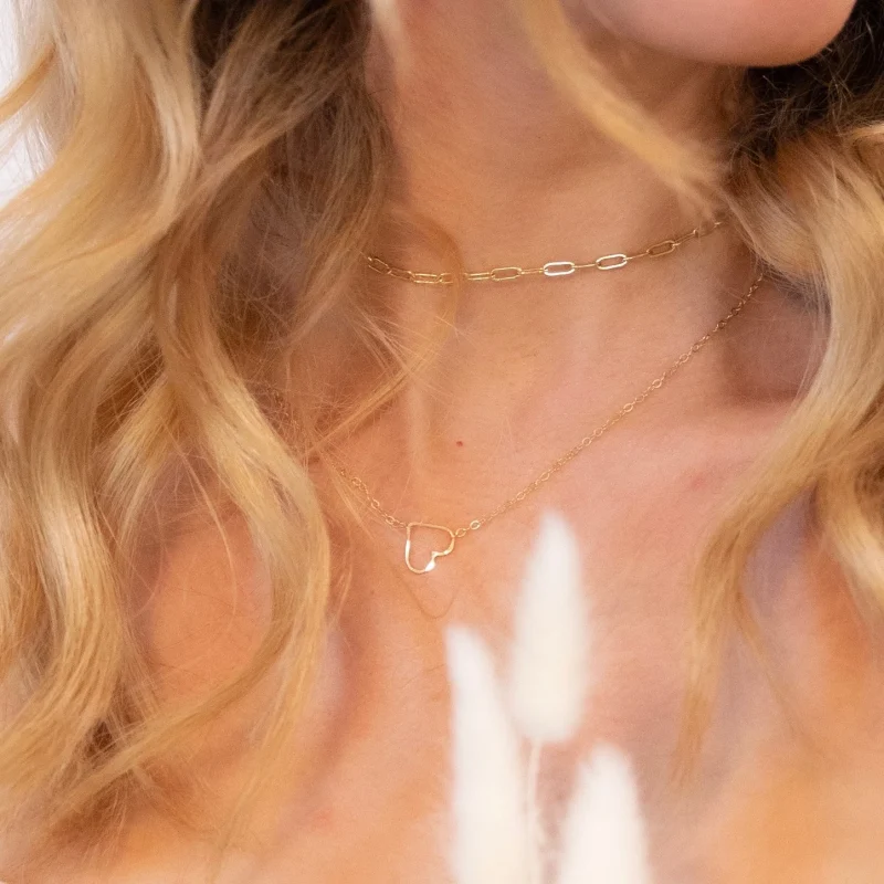 blond woman wearing gold heart necklace